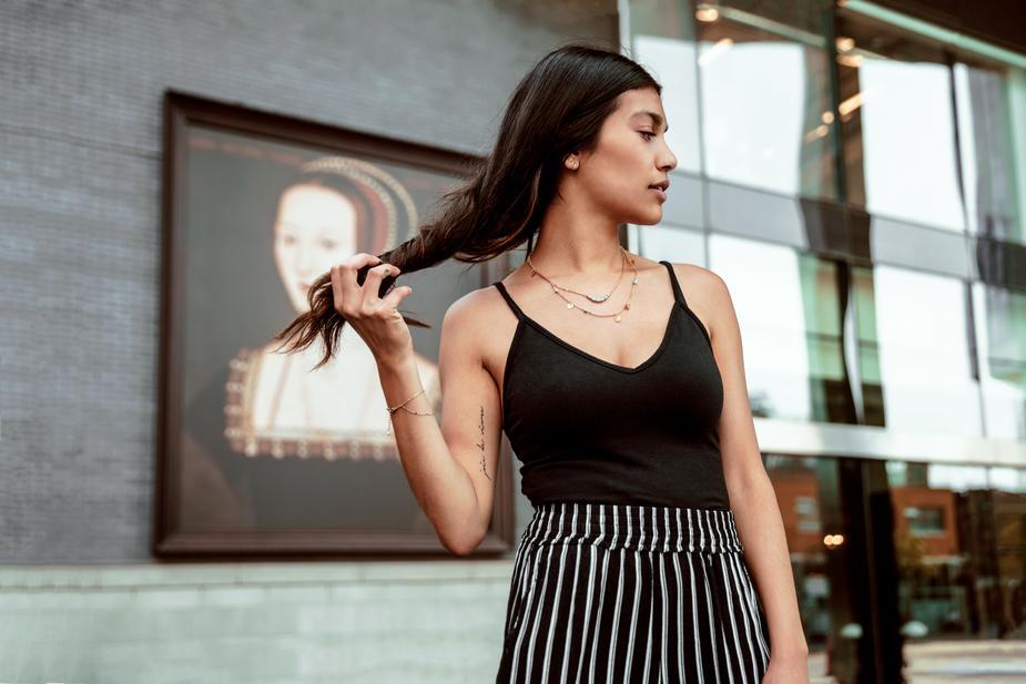 woman wearing striped skirt and black tank top